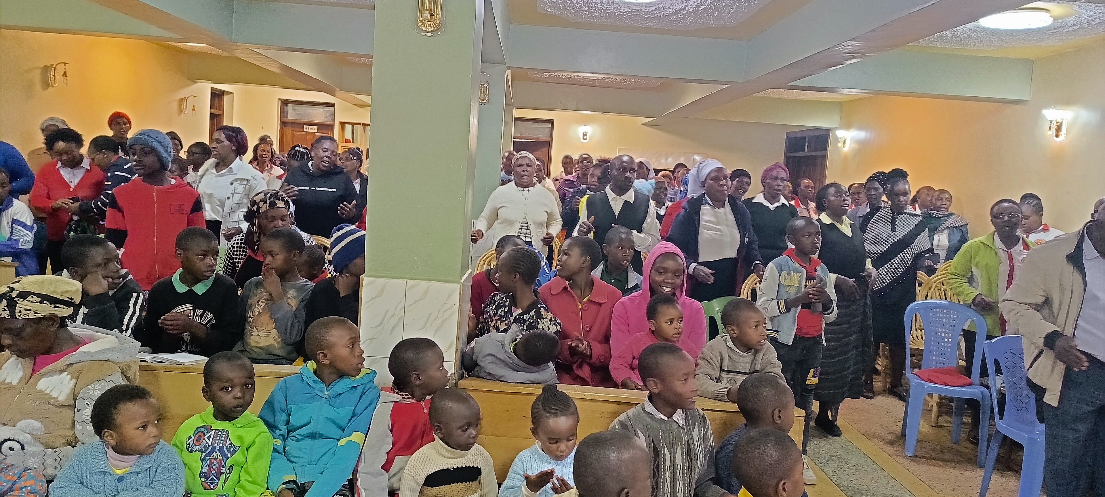 Children singing during a church service at Bethesda Child Care Centre