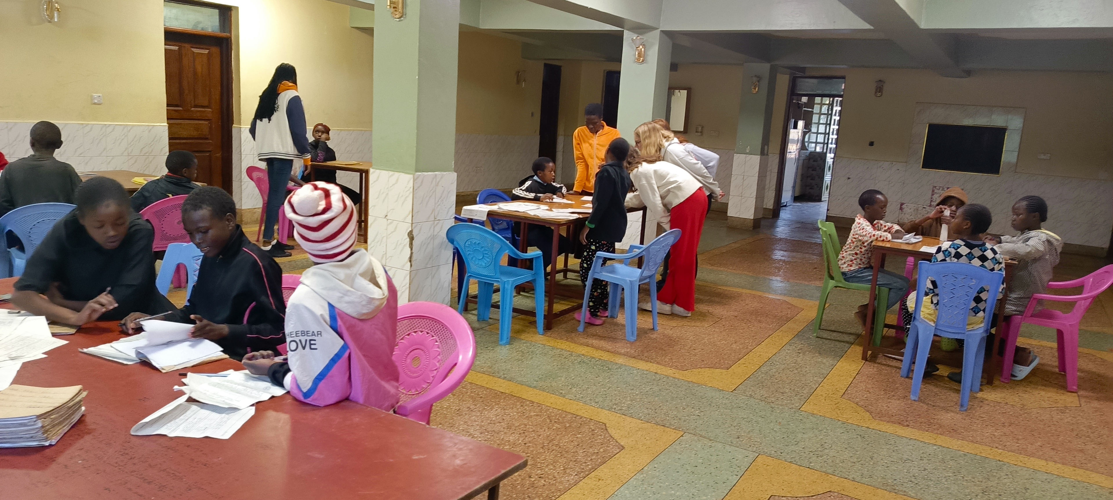 A volunteer spending time with older children at Bethesda Child Care Centre